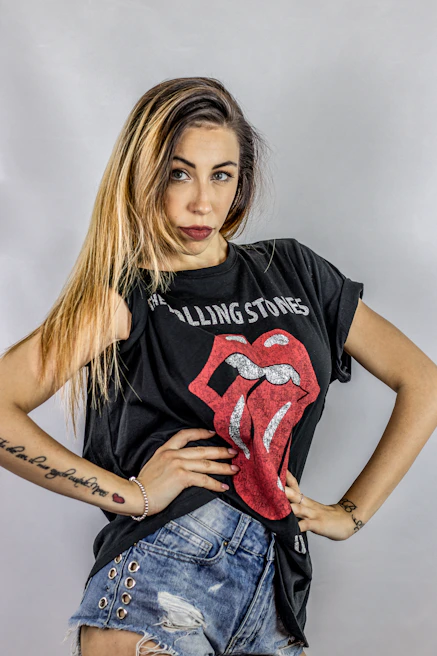 Close-up of a confident young woman flashing a perfect smile in a tattooed, edgy style