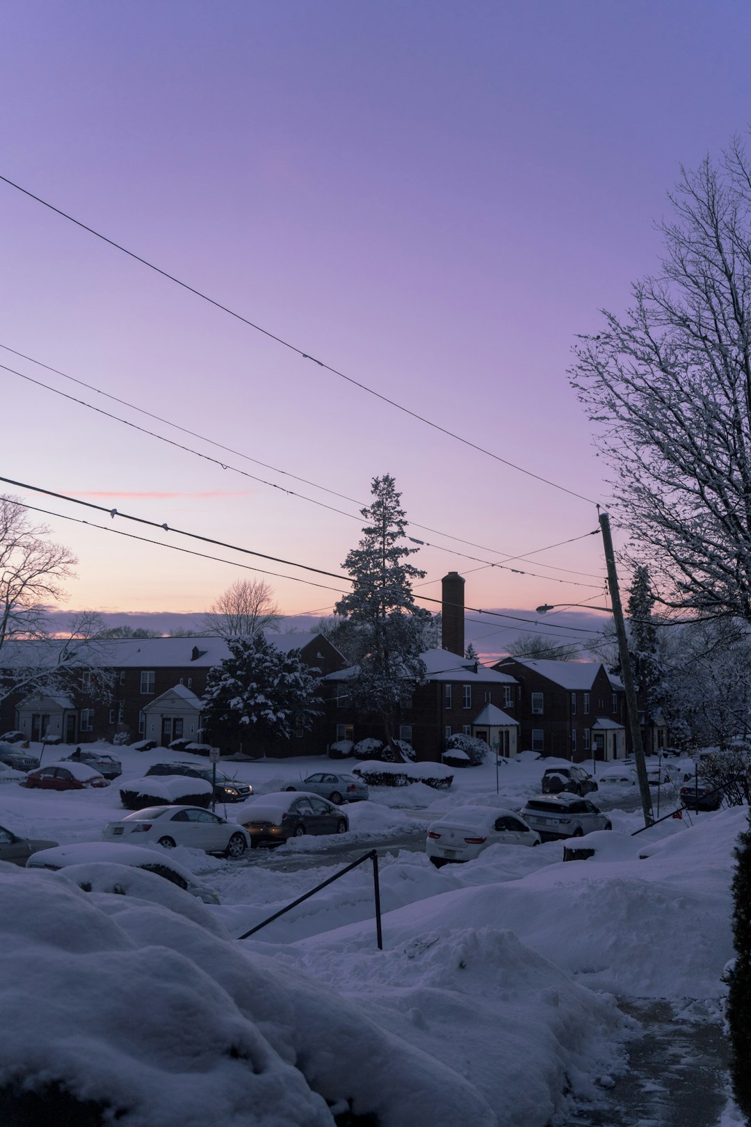 houses covered with snow under blue sky during daytime