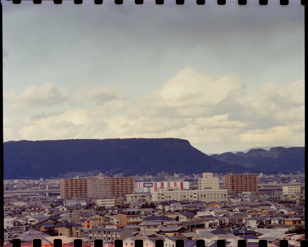 city buildings under white clouds during daytime