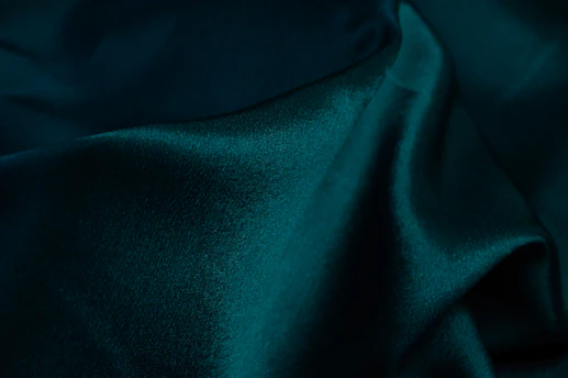 Model wearing dark green streetwear fabric with a subtle cool mist effect.