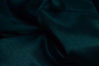 Rich emerald green velvet fabric catching the light with a plush, inviting surface.