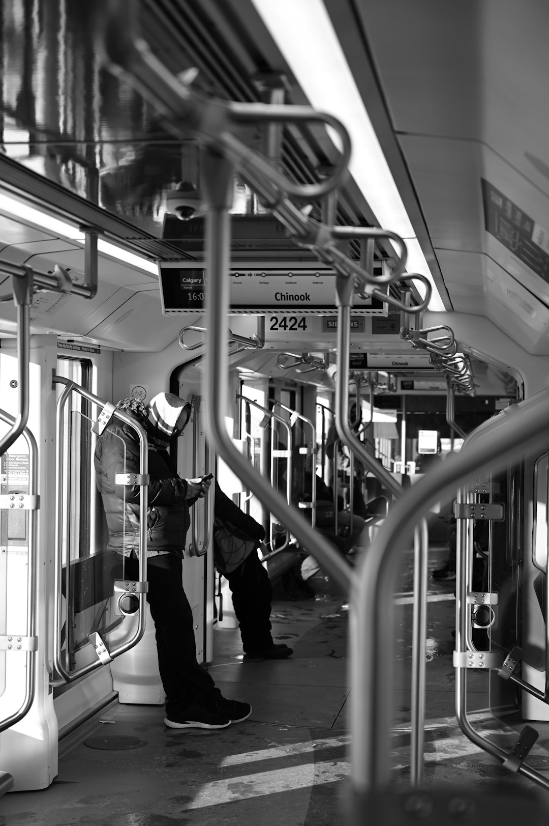 people walking inside train in grayscale photography