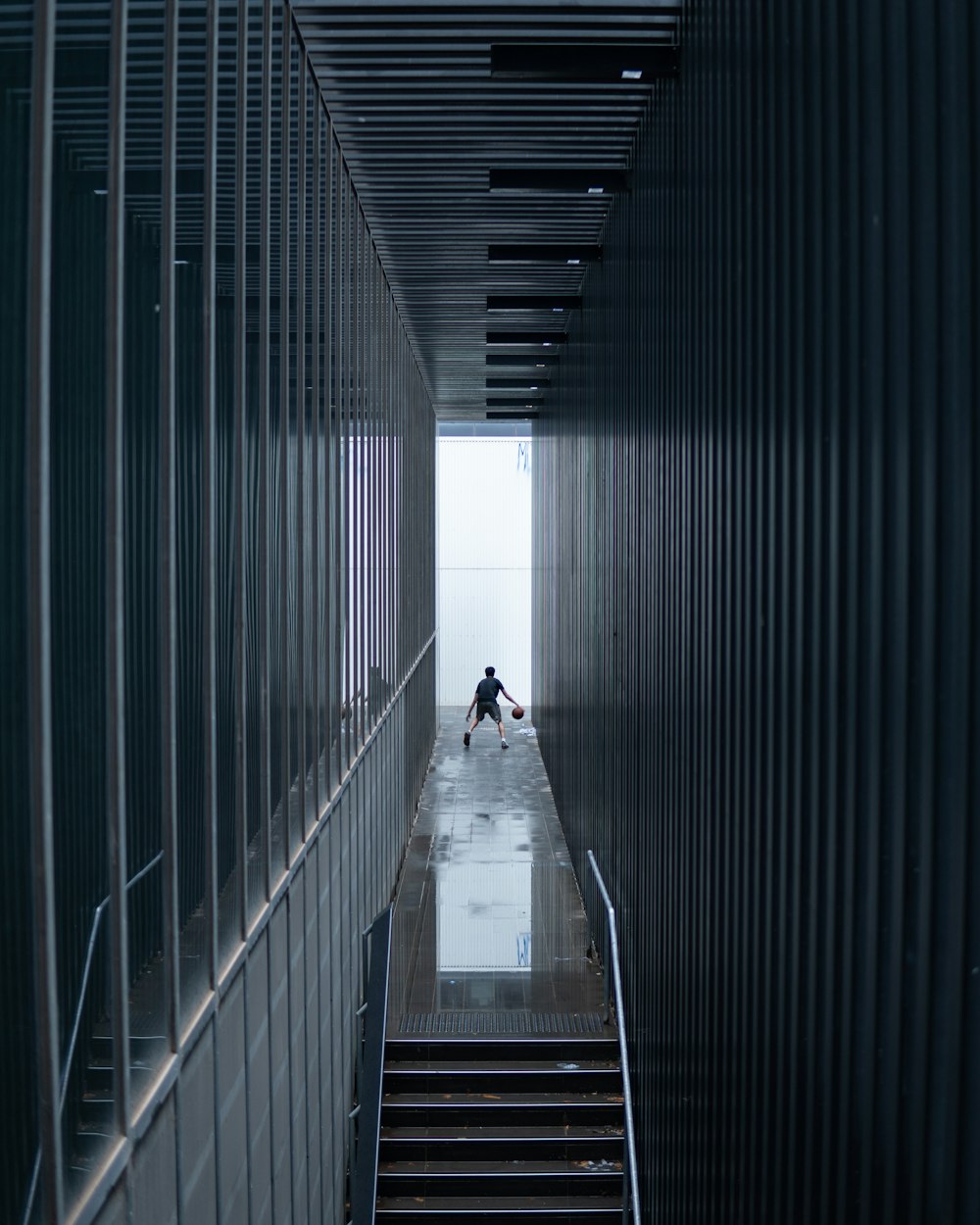 man in black jacket walking on hallway