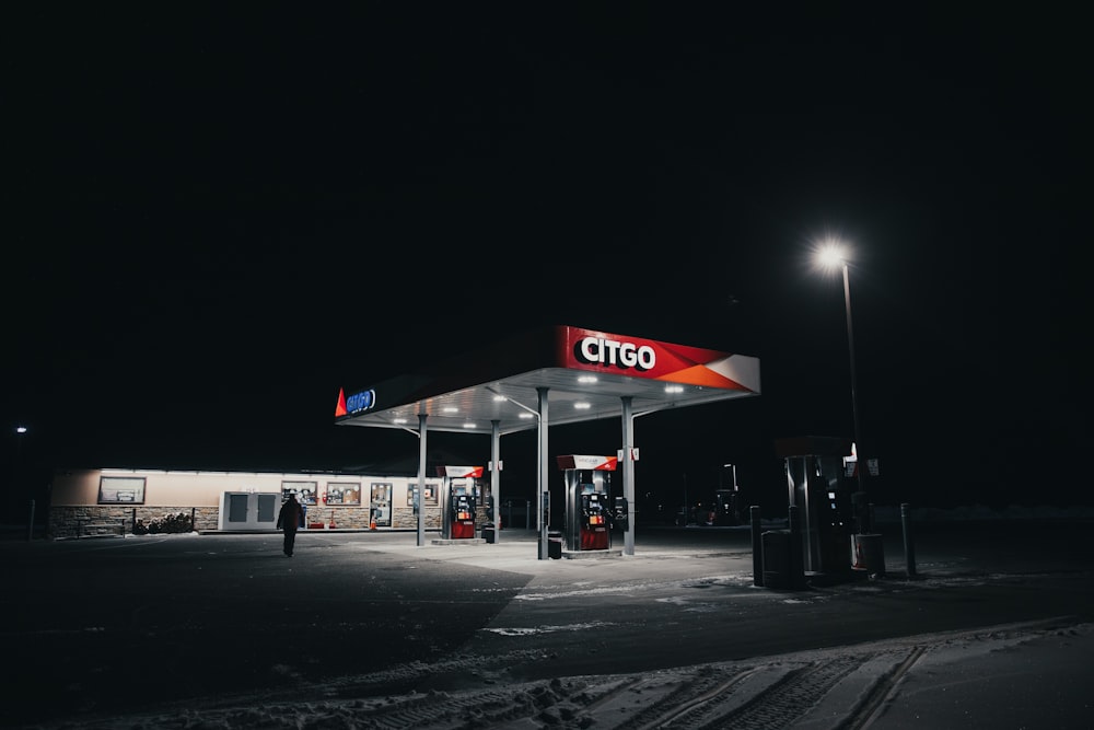 white and red gas station during night time