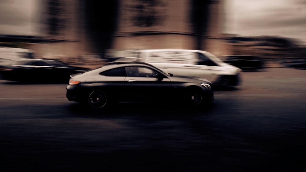 black coupe on road during night time