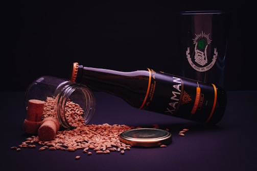 brown glass bottle beside brown round food