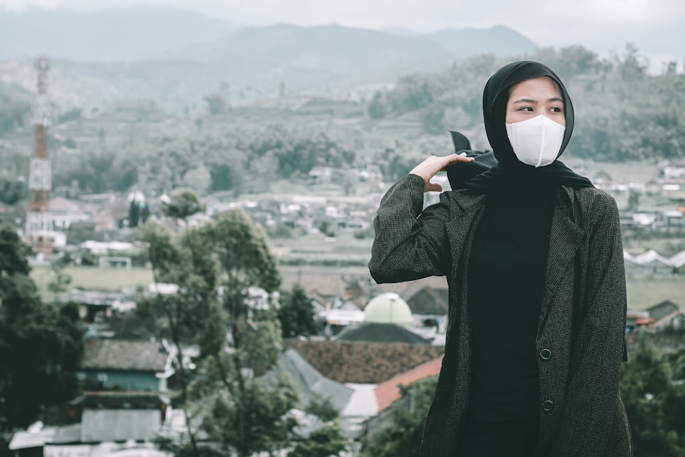 woman in black long sleeve shirt covering her face with white hijab