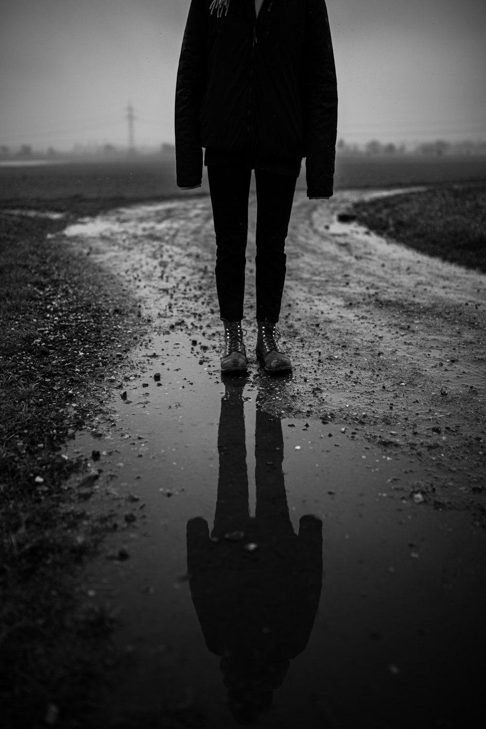 person walking on wet road