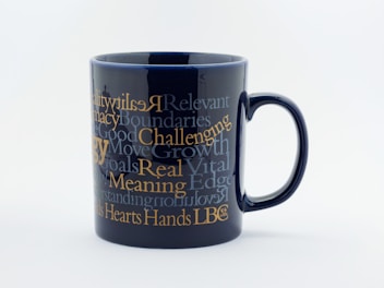 Close-up of a colorful ceramic mug with a witty slogan printed on it.
