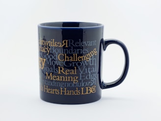Close-up of a colorful ceramic mug with a witty slogan printed on it.