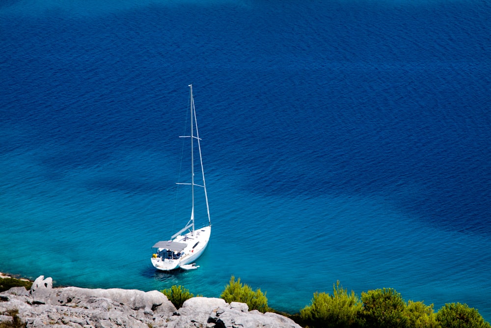 white sailboat on blue sea during daytime