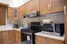 white microwave oven on brown wooden kitchen cabinet