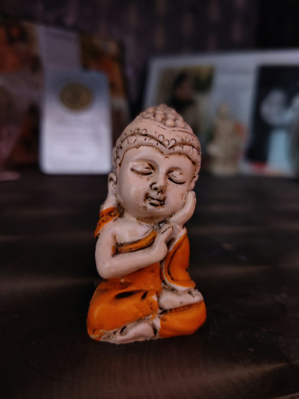 brown ceramic buddha figurine on black table