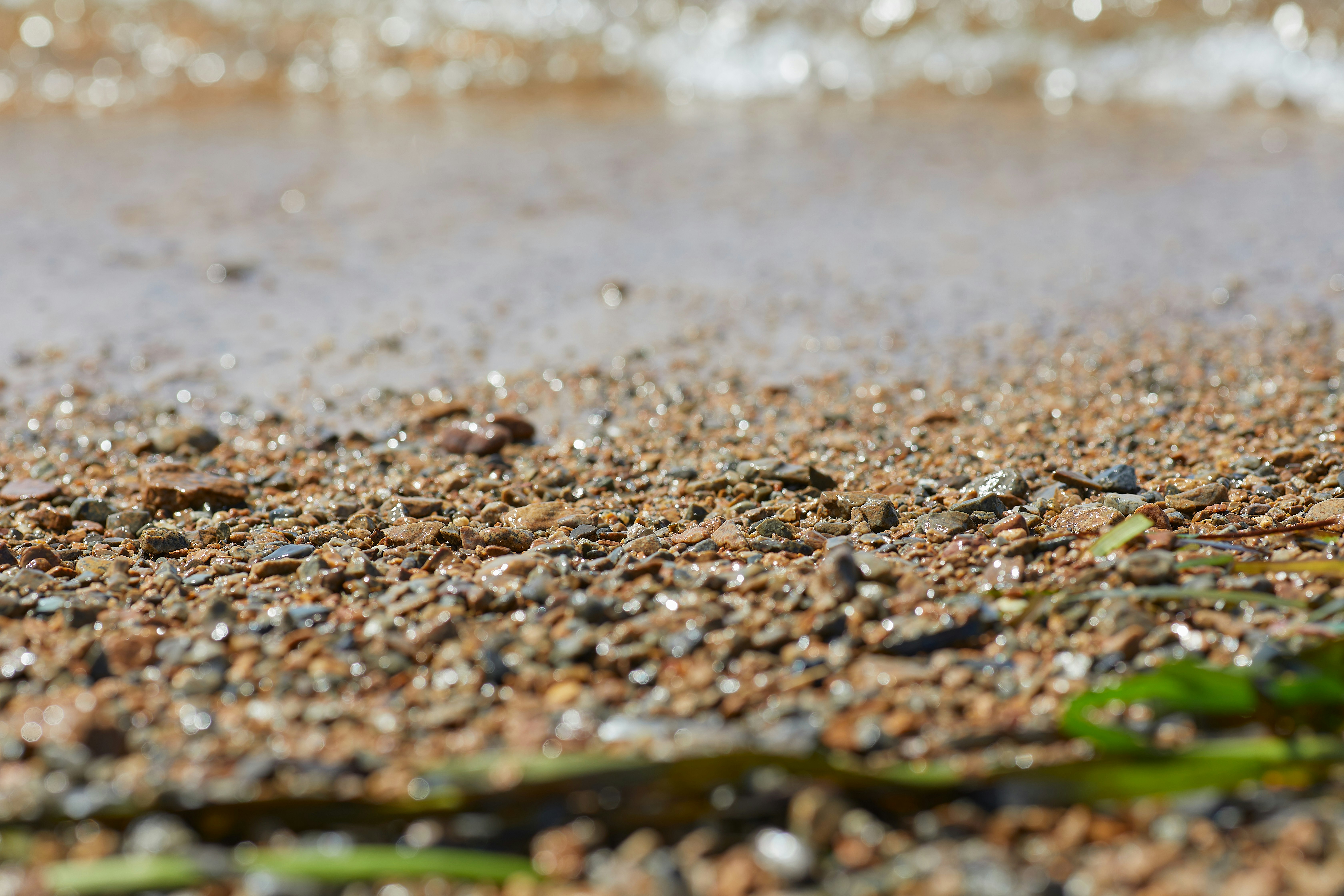 brown and black stones near body of water during daytime