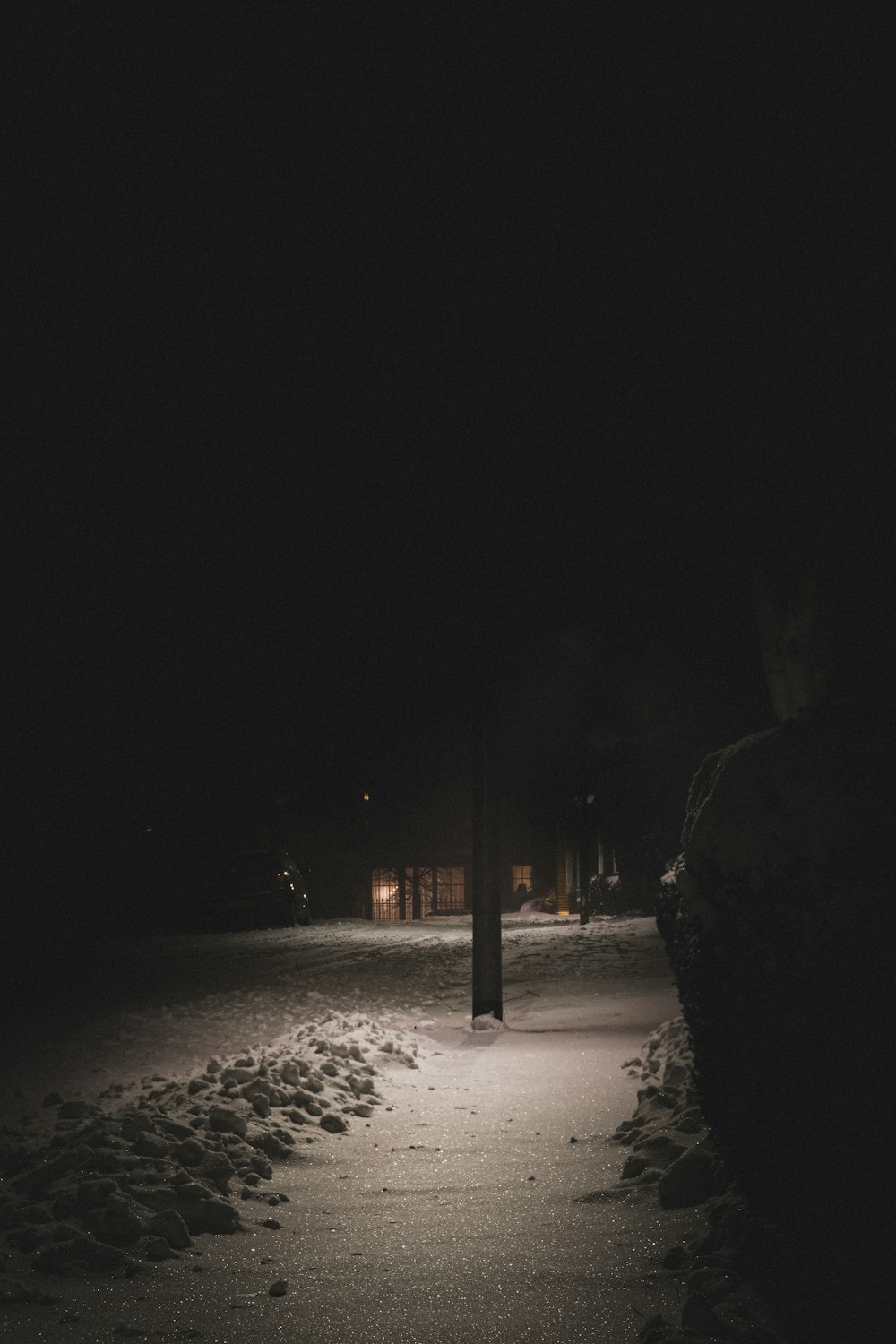 person standing on snow covered ground during night time