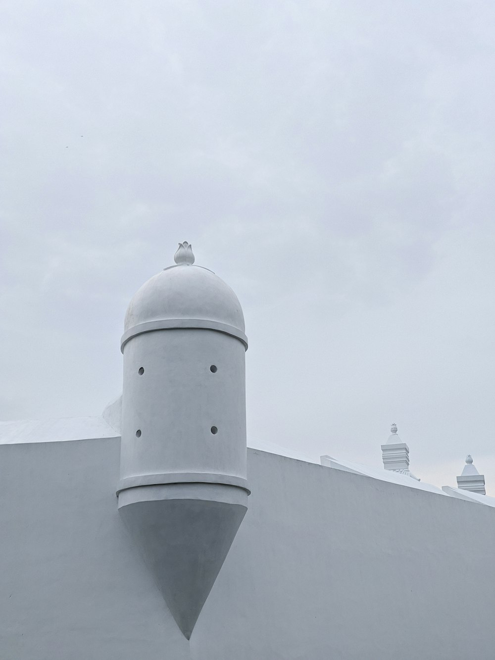 white concrete building under white sky during daytime