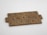 Wooden Scrabble tiles arranged to spell the phrase 'GENIUS DEMANDS EFFORT', placed on a light surface.