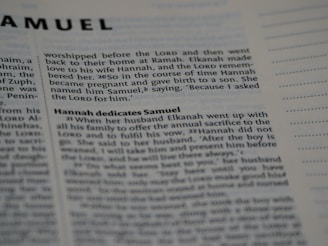 A close-up photo of a Bible page, showing the text from the book of Samuel. The passage discusses Hannah and her son, Samuel. The text is in English and the focus is on a specific scripture narrative.