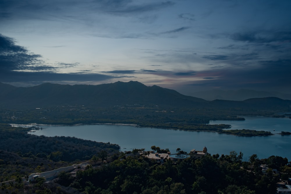 body of water near mountain during daytime