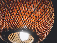 Close-up of handcrafted rattan lampshades carefully packed and ready for export.