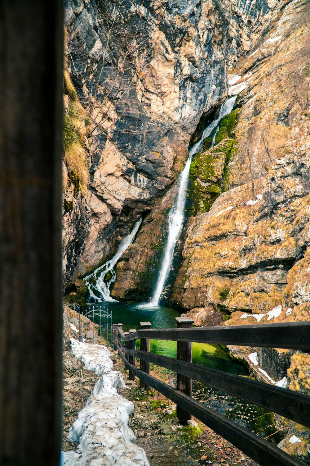 Grüne Holzbrücke über Wasserfälle
