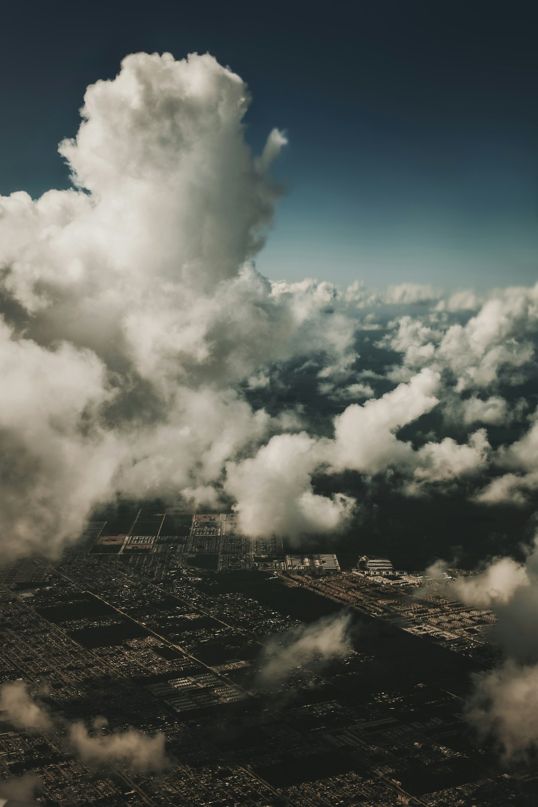 white clouds over city buildings during daytime