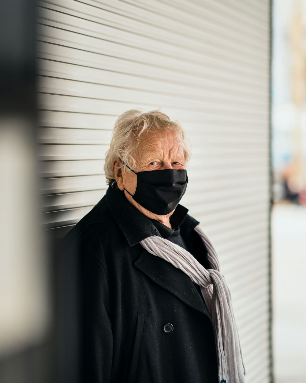 woman in black coat wearing black sunglasses