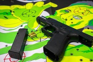black semi automatic pistol on green and white textile