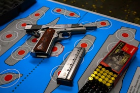 gray and black semi automatic pistol on blue and white book