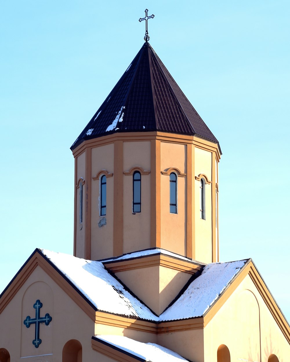 blue and yellow concrete church under blue sky during daytime