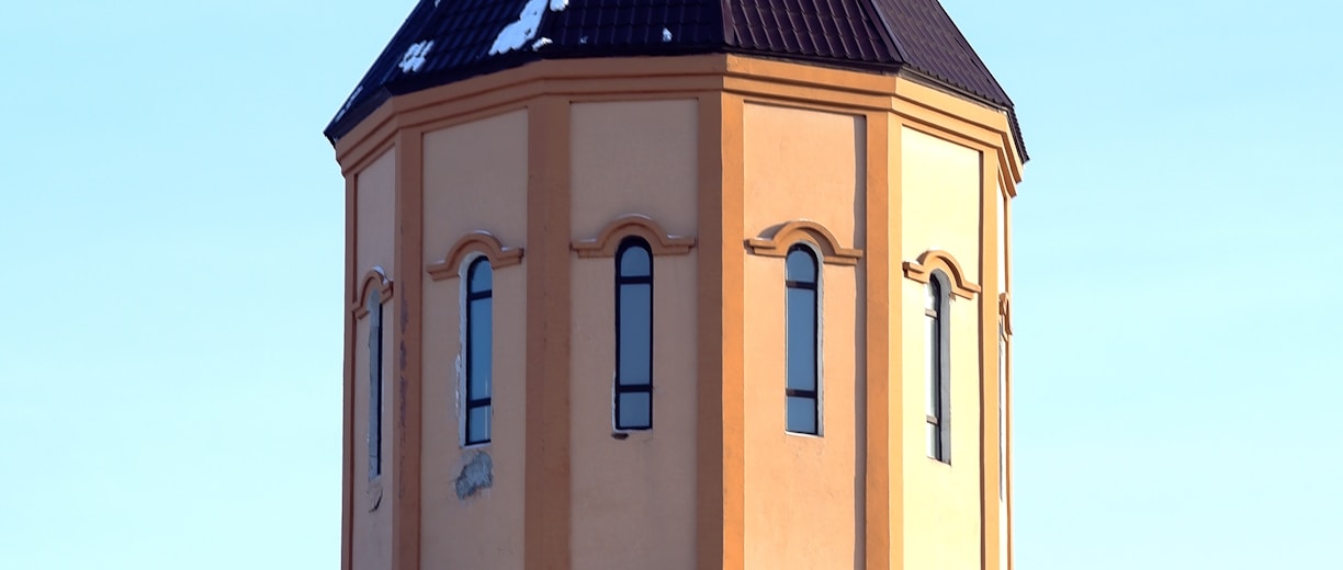 blue and yellow concrete church under blue sky during daytime