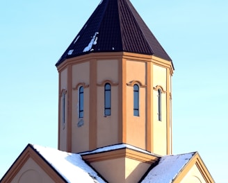 blue and yellow concrete church under blue sky during daytime