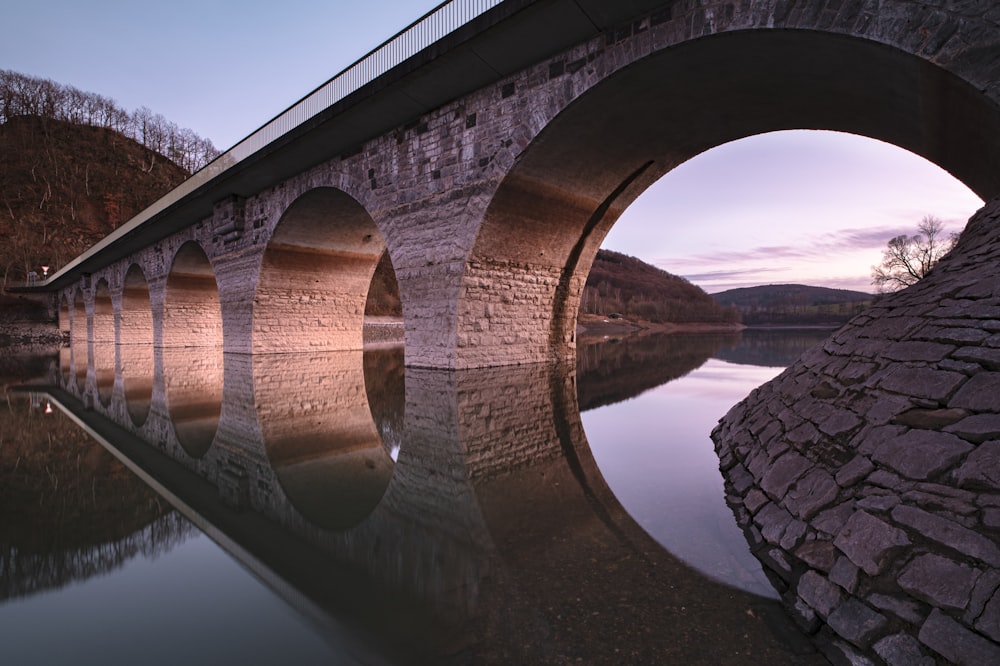 brown concrete bridge over river during daytime