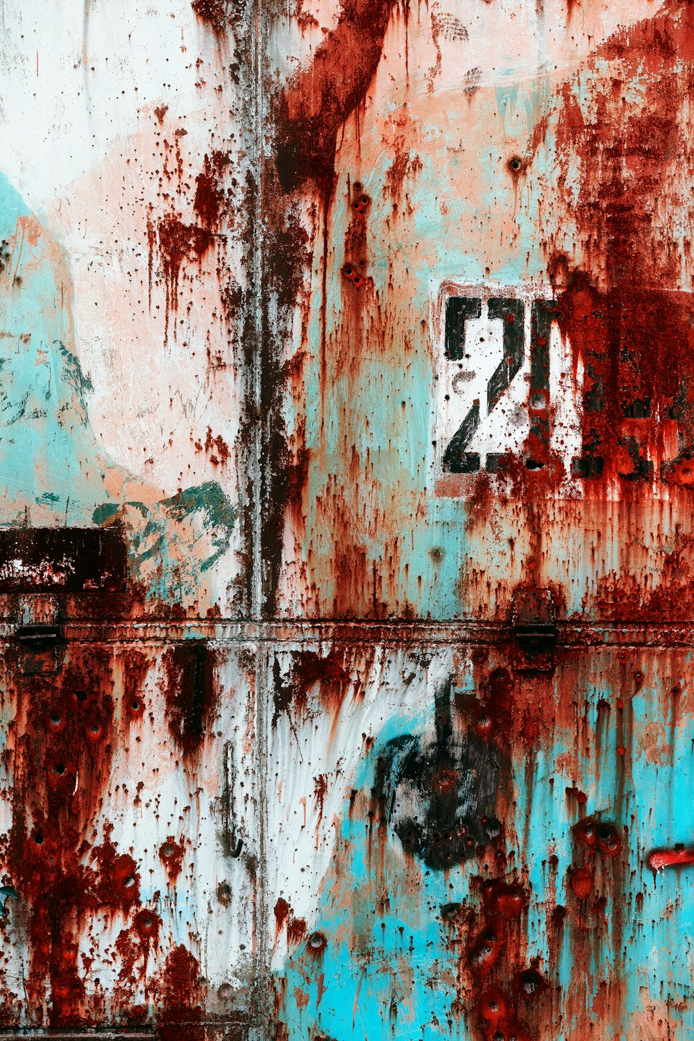 a rusted metal wall with a clock on it