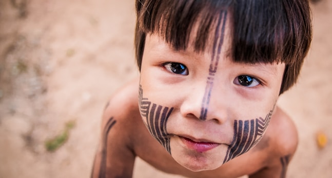 topless boy with black and white face paint