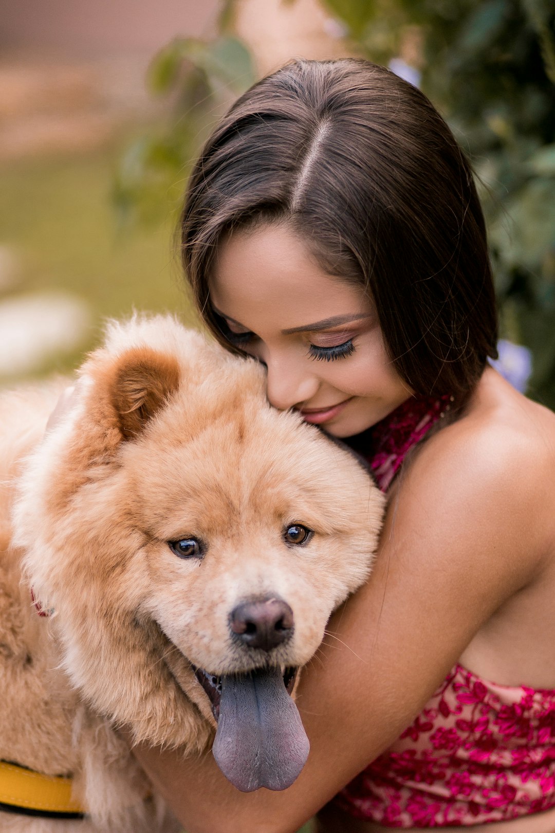 girl in pink tank top hugging brown long coated dog