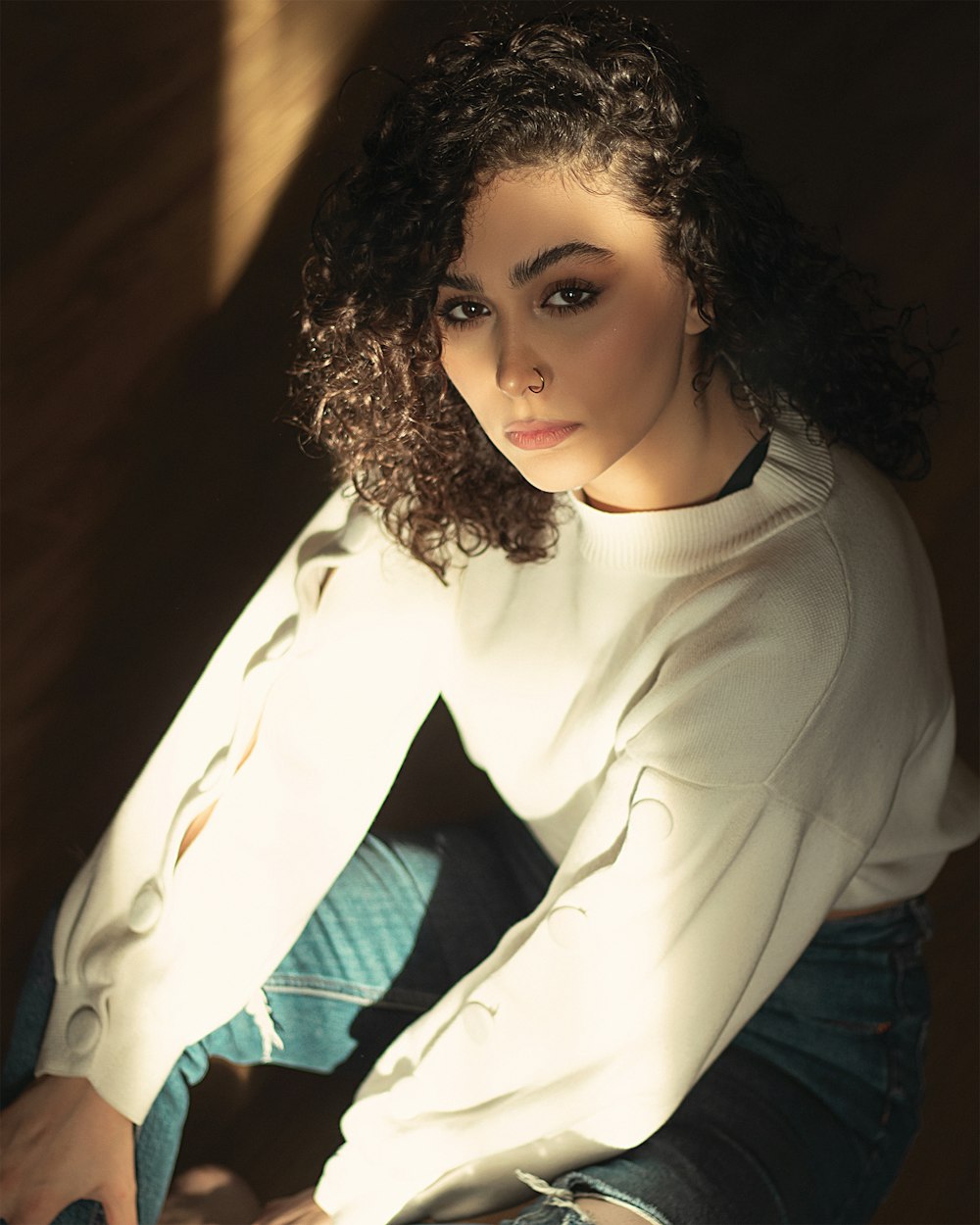 woman in white turtleneck long sleeve shirt and blue denim jeans