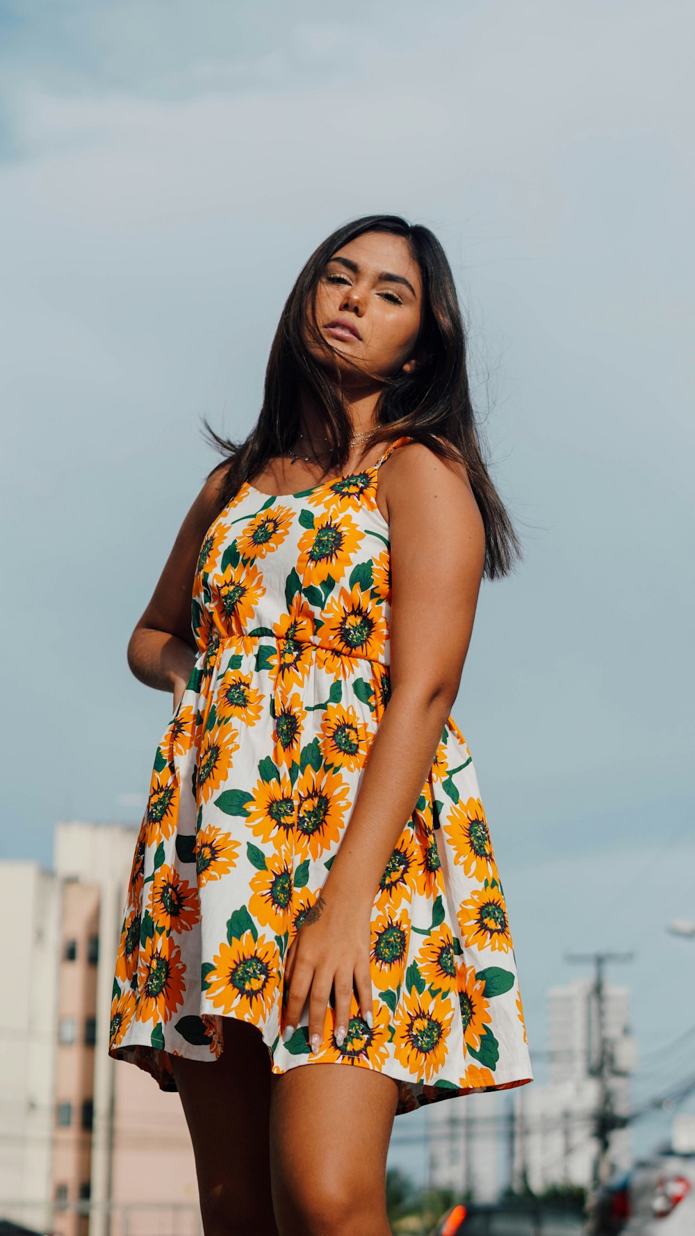 woman in white yellow and blue floral sleeveless dress