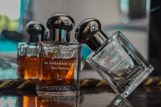 selective focus photography of clear glass perfume bottle