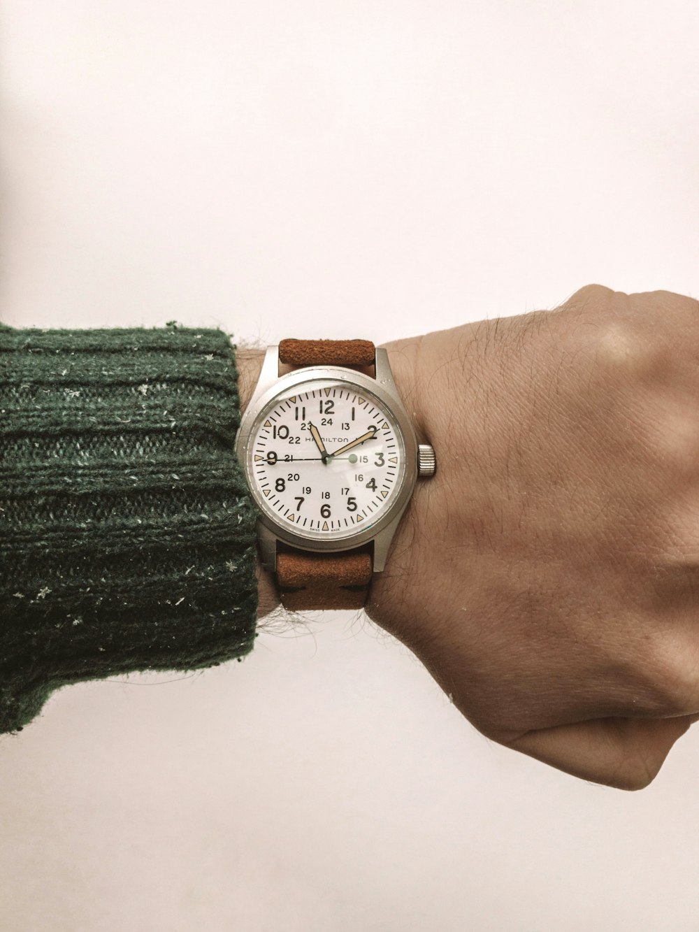 person wearing silver round analog watch