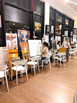 woman in gray long sleeve shirt sitting on white chair