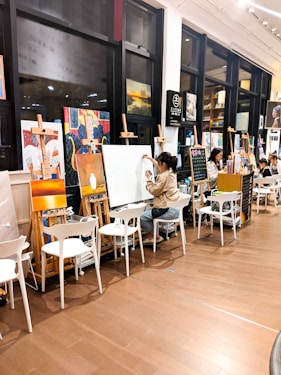 woman in gray long sleeve shirt sitting on white chair