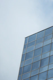 Close-up of a sleek modern window with double glazing reflecting a bright sky.