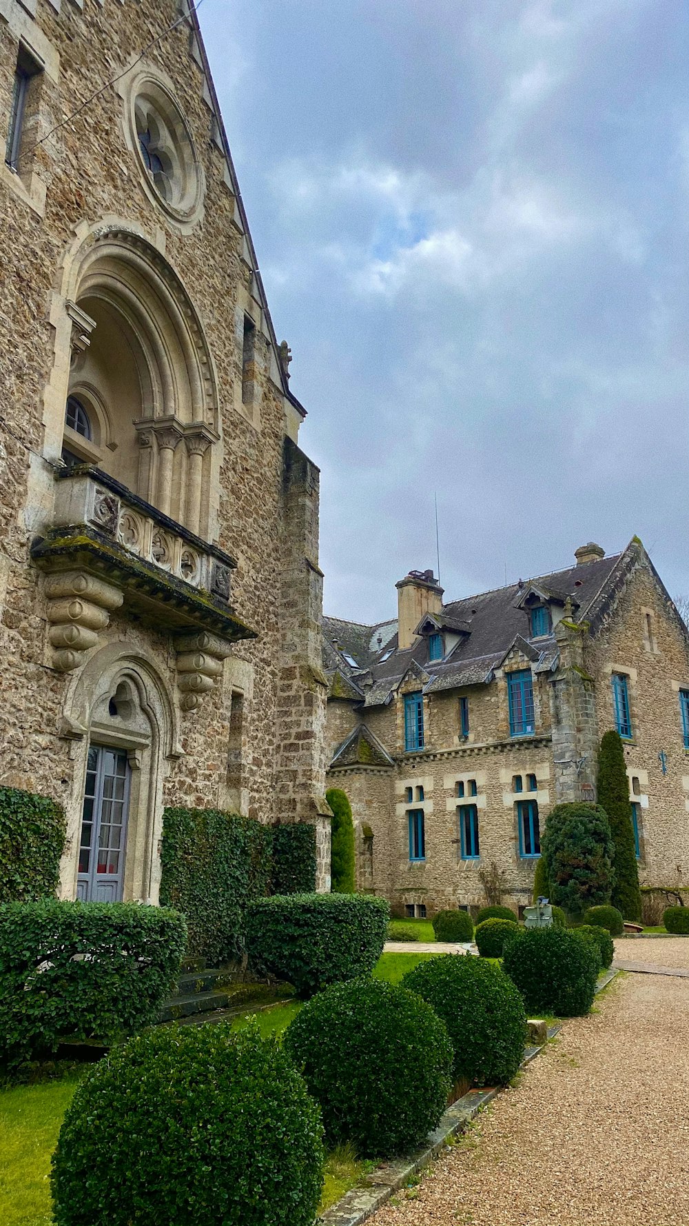 a large stone building with a clock on the front of it