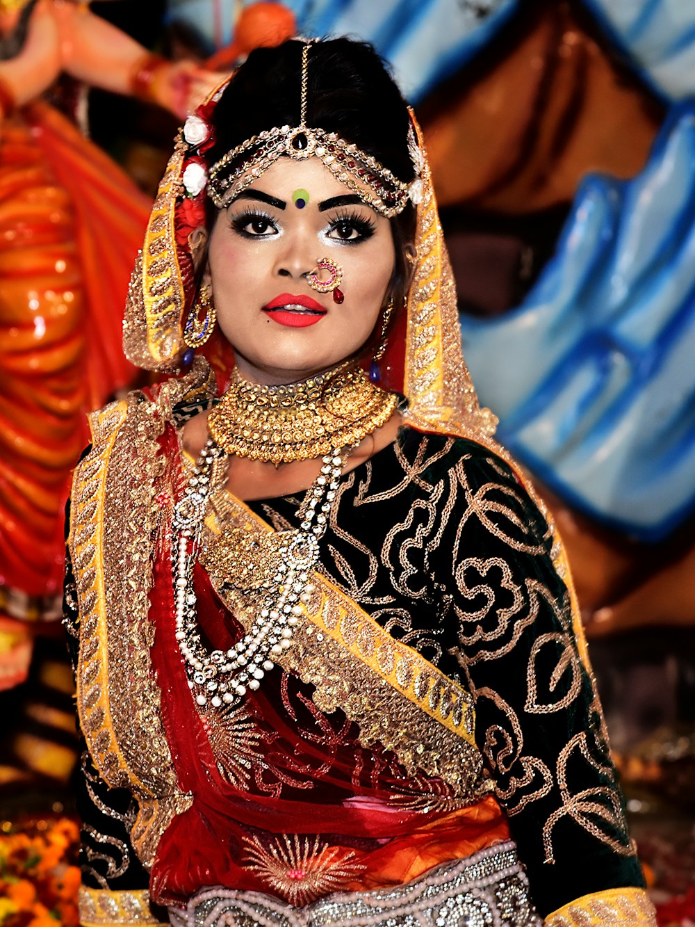 woman in red and gold sari dress