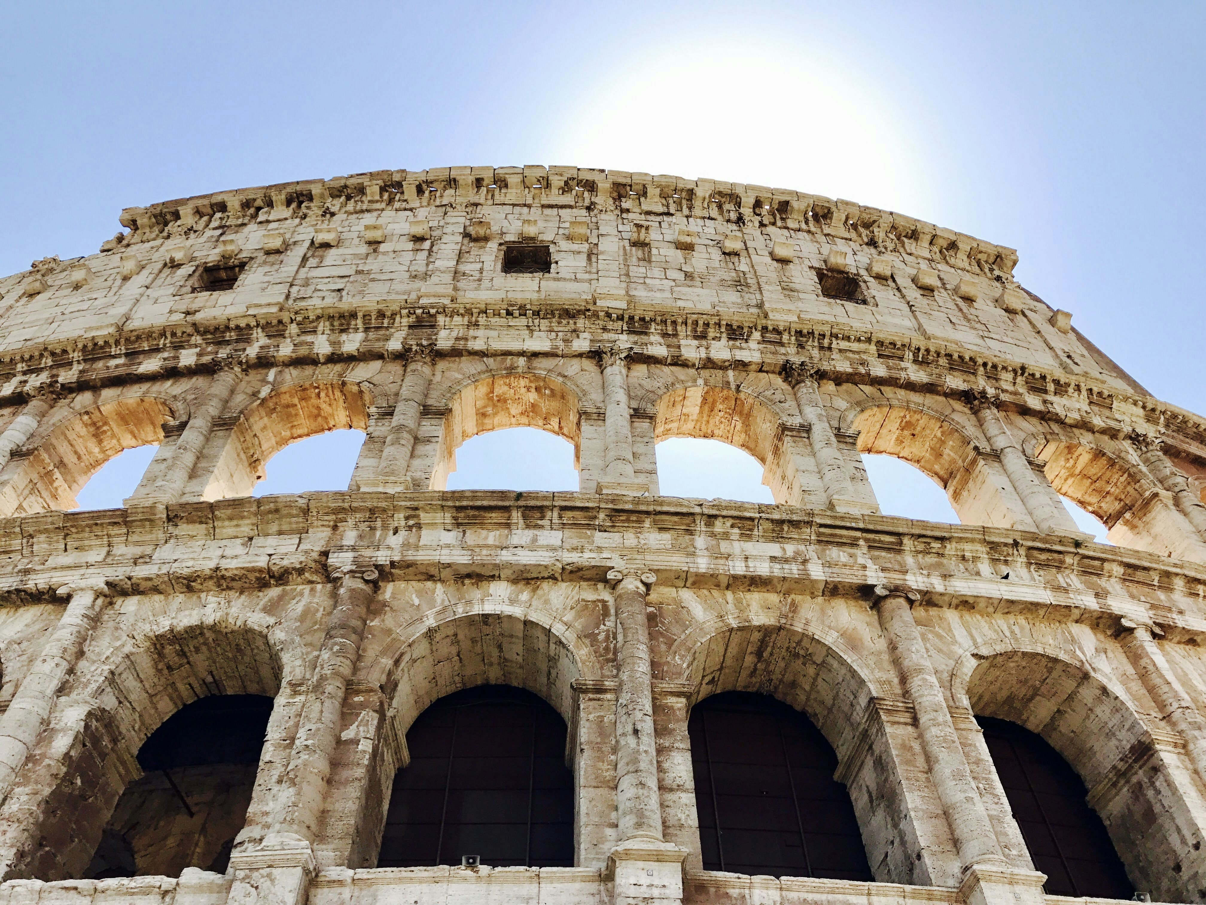 brown concrete building under blue sky during daytime, Colosseum in Rome