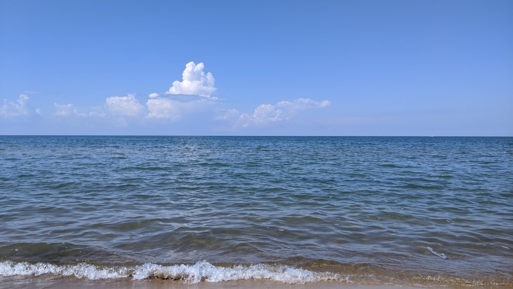 ocean waves under blue sky during daytime