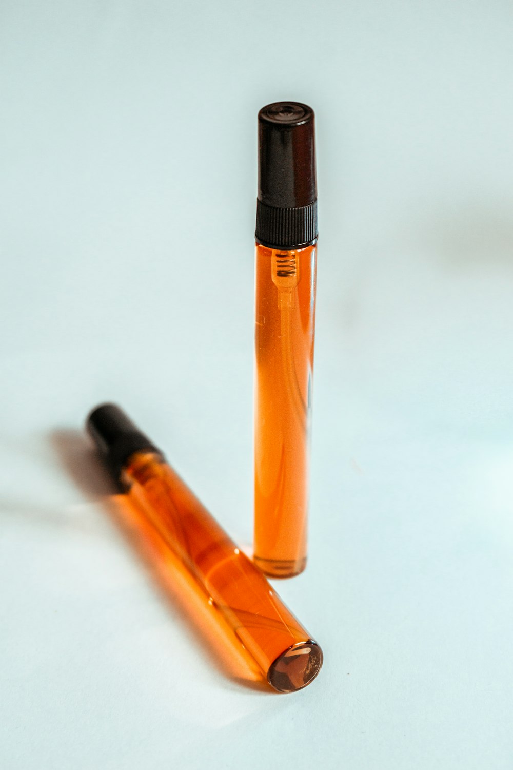 orange and black pen on white table