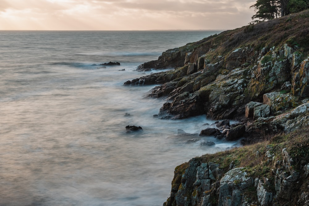 ocean waves crashing on rocky shore during daytime