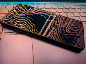 Close-up of a sleek smartphone case with a matte finish resting on a modern laptop keyboard